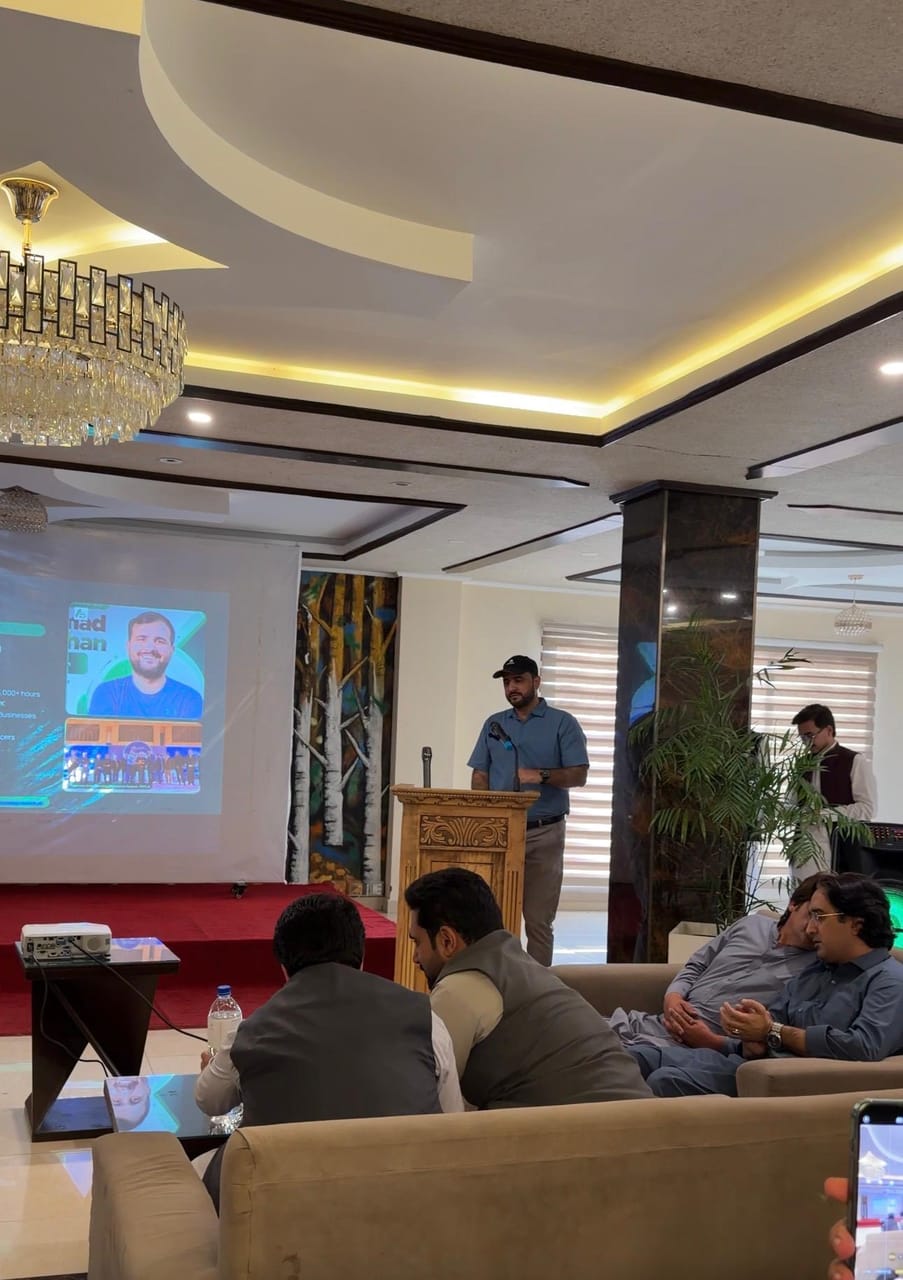 Guest speaker presenting from the podium at the Digital KP Network meetup at Swat Palace